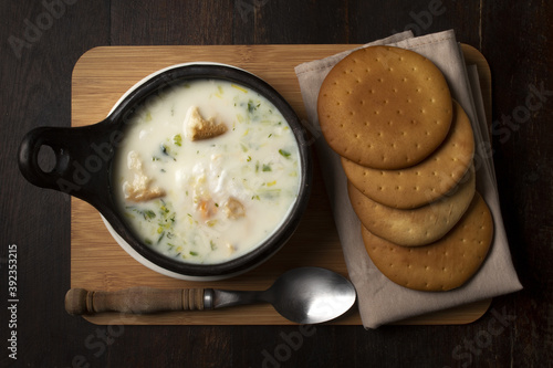 Top view of a traditional Colombian soup changua with round pieces of crunch biscuits photo