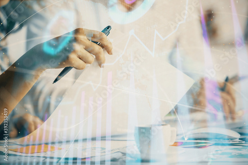 Double exposure of forex graph drawing over people taking notes background. Concept of financial analysis