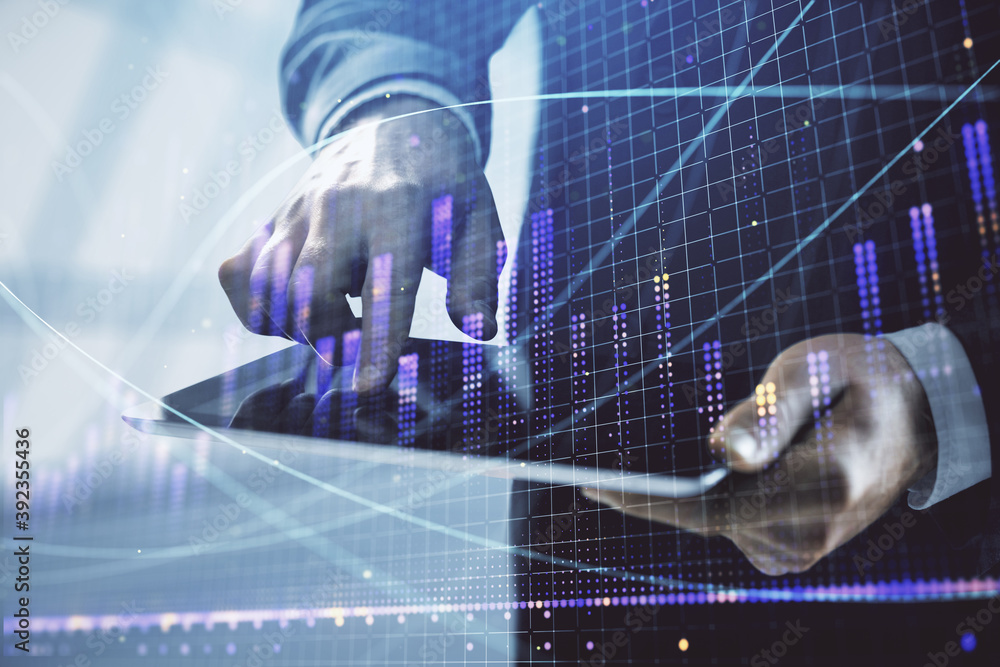Fototapeta premium Double exposure of man's hands holding and using a digital device and forex graph drawing. Financial market concept.