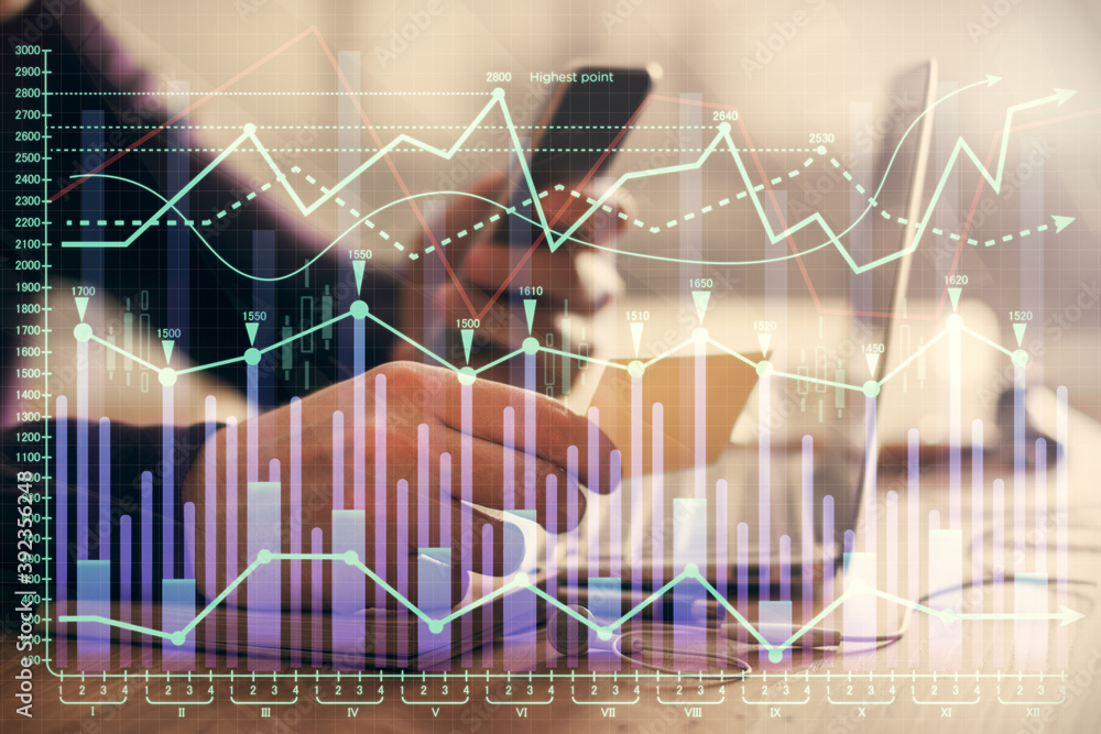 Double exposure of man's hands holding and using a phone and financial graph drawing. Analysis concept. Double exposure of man's hands holding and using a phone and financial graph drawing. Analysis concept.