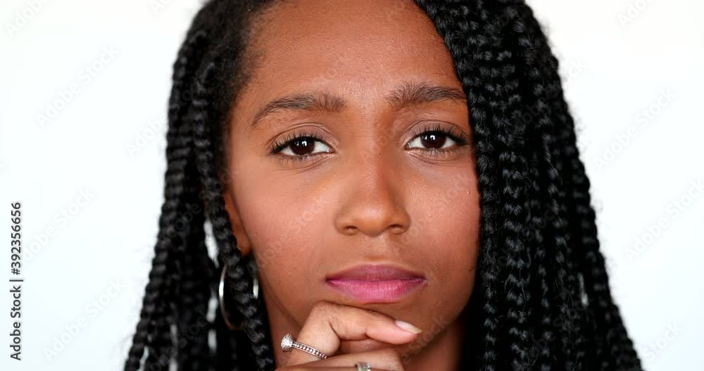 Pensive black African girl thinking, portrait teen daydreaming. Thoughtful contemplative young woman Pensive black African girl thinking, portrait teen daydreaming. Thoughtful contemplative young woman