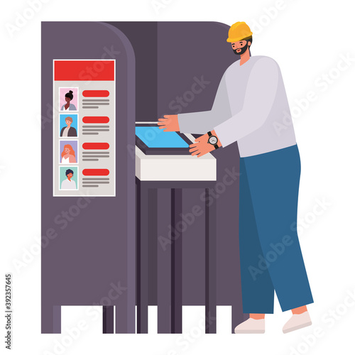 man voting with black hair and safety helmet in gray voting booth