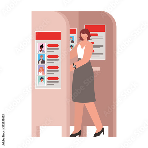 woman voting with reddish hair and white shirt in voting booth