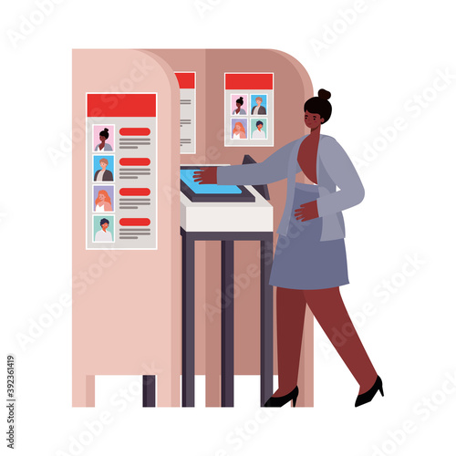 woman with black hair and a gray suit in voting booth