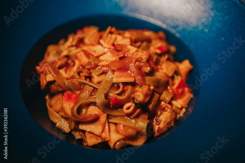 Slika na platnu Closeup of deliciously cooked pasta with sauce, pepper, and vegetables in a bow