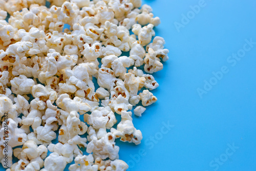Popcorn on blue background. Copy space