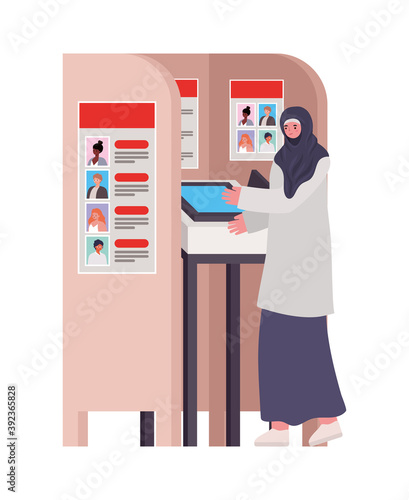 woman dressed in hijab and gray dress in a voting booth