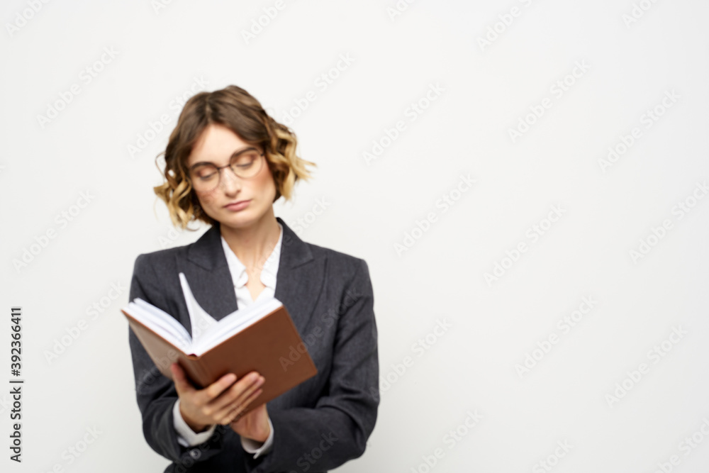 business woman in a suit with documents in hands light background curly hair hairstyle business woman in a suit with documents in hands light background curly hair hairstyle