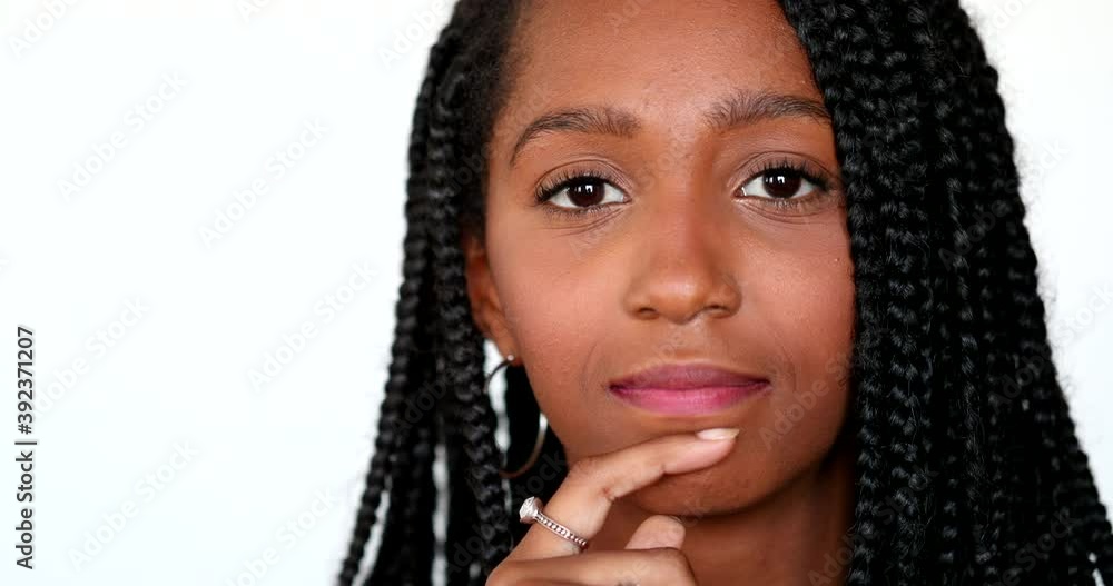 Teenager black African girl portrait close-up face looking at camera Teenager black African girl portrait close-up face looking at camera