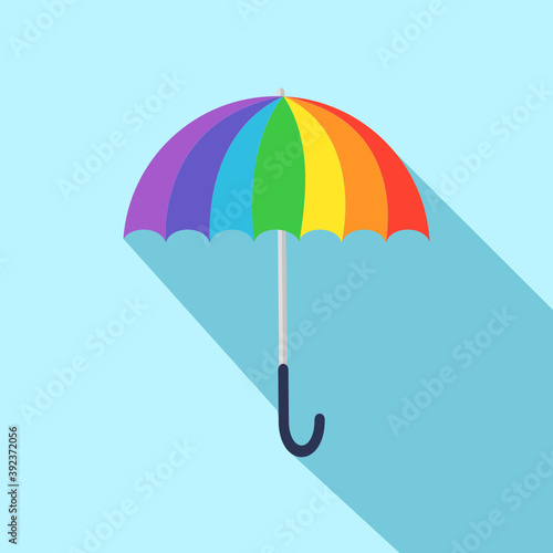 Rainbow umbrella with long shadow isolate on blue background.
