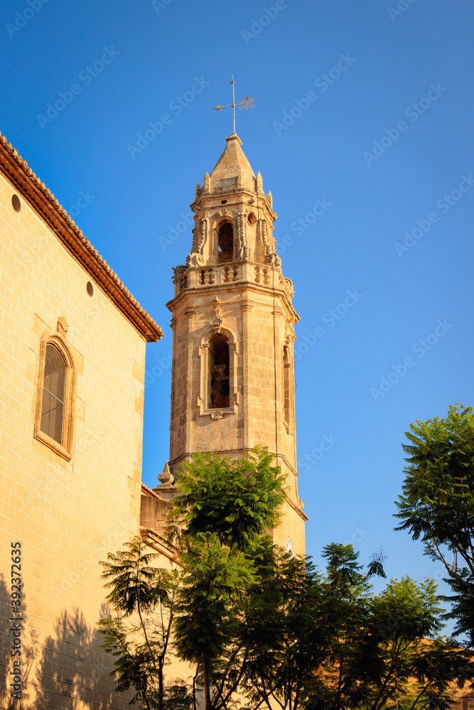 San Pere Church's tower in Torredembarra,  Tarragona, Spain - at sunset. Day with blue sky.
