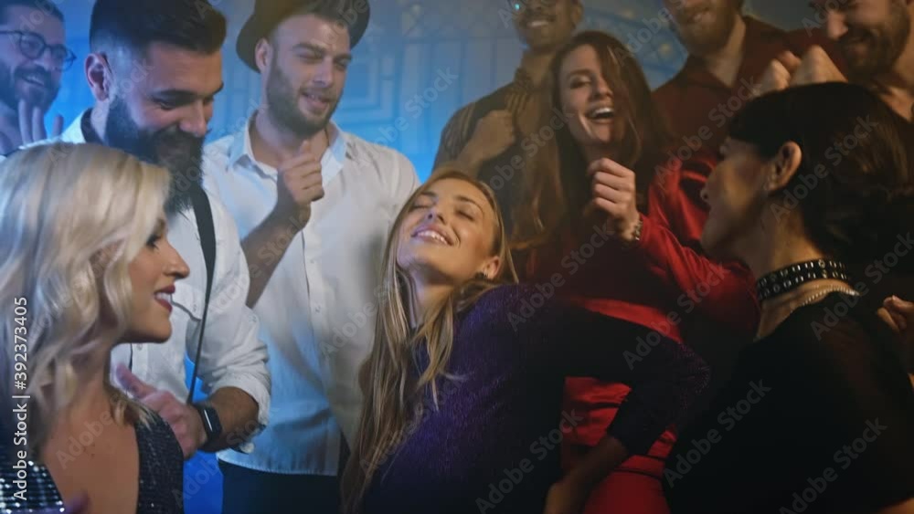 Energetic party people dancing in club Energetic party people dancing in club