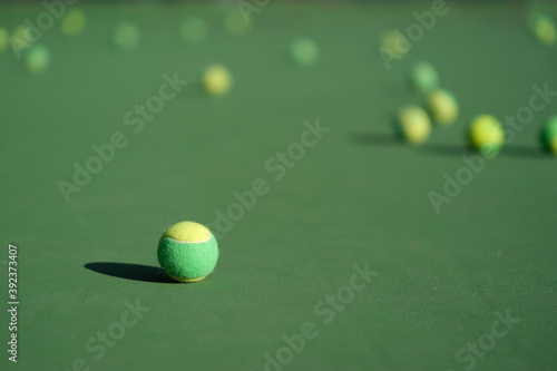 close up many tennis ball on tennis court ground under sunlight. Blur background © Robert