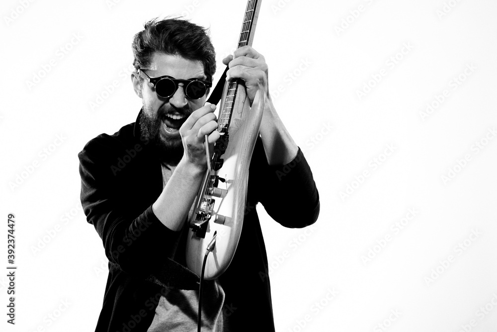 Obraz premium Man with guitar music performance entertainment contemporary performer sunglasses studio