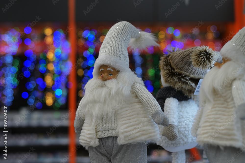 Close-up Photo of New Year's white figures of Santa Claus on a blurred background