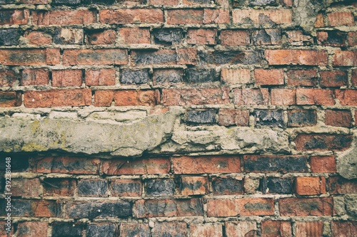 Old weathered brick wall fragment .