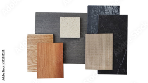 interior material board including brown laminated, oak engineer flooring, veneer, black marble artificial stone and beige graines quartz stone samples isolated on white background with clipping path. photo