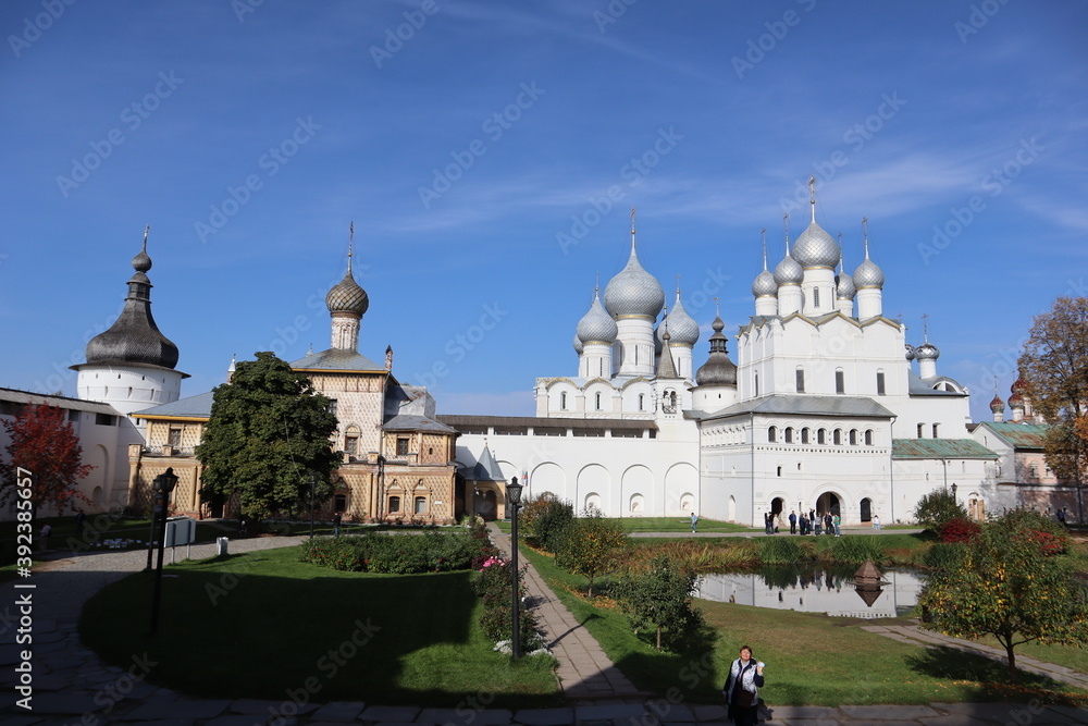 Beautiful white Christian Church on the background of blue sky and sun, historical landscape, architectural ensemble