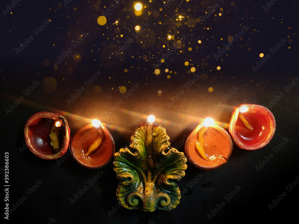 Happy Diwali. Background picture of traditional diya clay oil lamp lit at  dark night on Diwali with copy space in landscape format. Stock Photo |  Adobe Stock