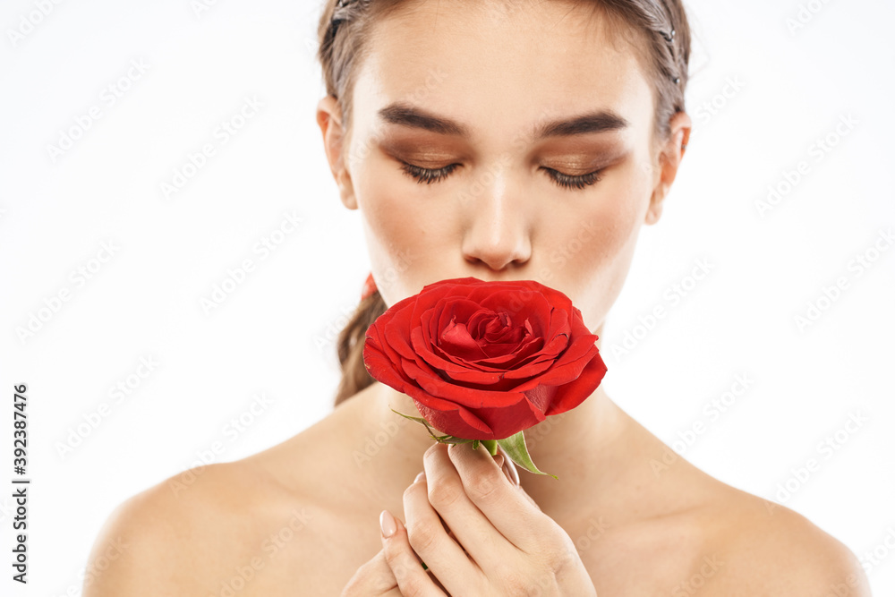 charming brunette girl with makeup on her face and a red rose in her hand charming brunette girl with makeup on her face and a red rose in her hand