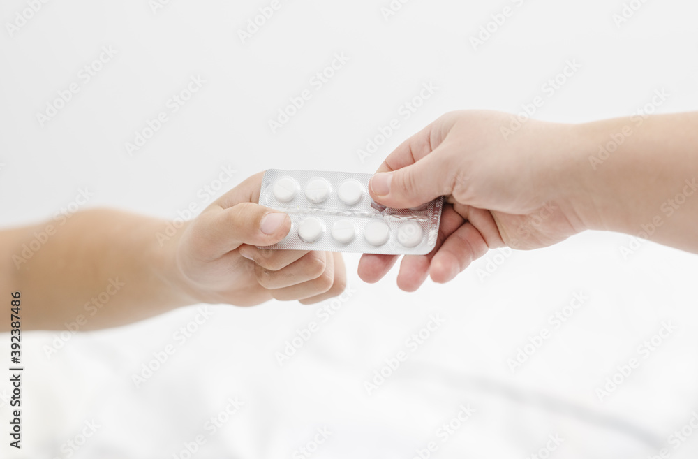 Hands pass a block of pills to each other. Season of colds concept Hands pass a block of pills to each other. Season of colds concept