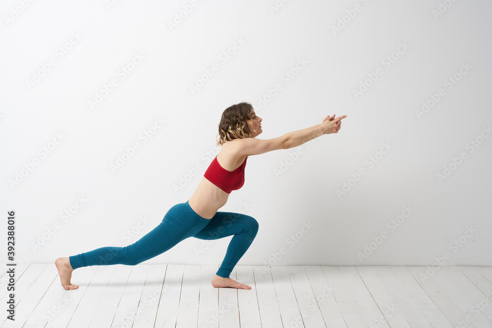 woman in leggings is engaged in gymnastics in a light room slim figure fitness sport
