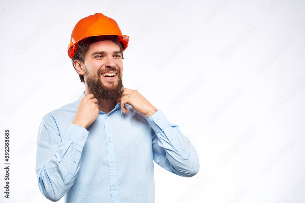 Man in blue shirt orange hard hat professional construction safety engineer