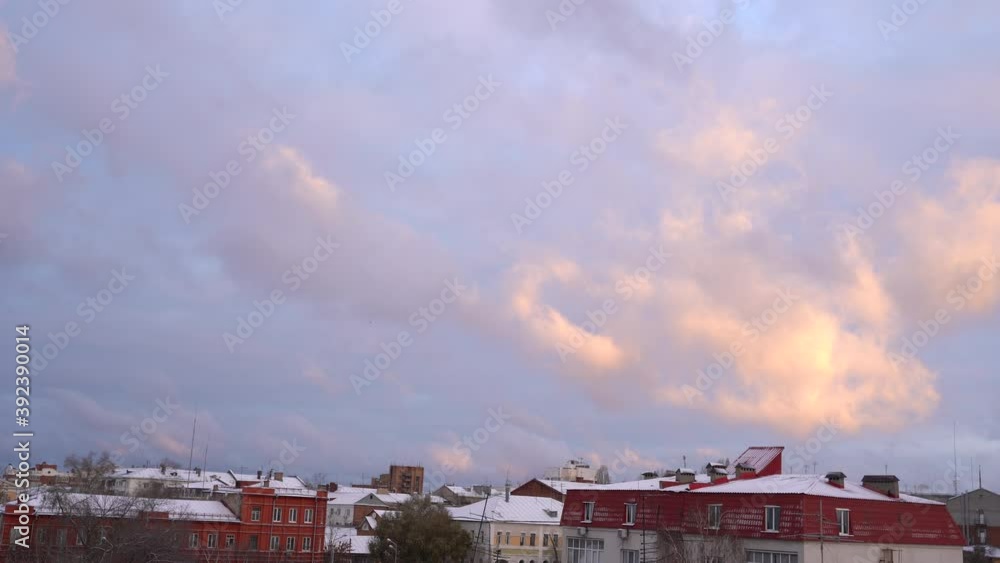 Beautiful evening blue sky at sunset with blazing bright light, clouds illuminated by rays of sunlight slowly floating across the sky, clouds. Beautiful evening blue sky at sunset with blazing bright light, clouds illuminated by rays of sunlight slowly floating across the sky, clouds.