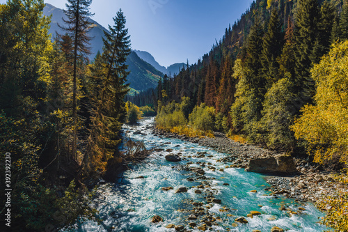 Canyon of mountain river with blue water. Autumn in Caucasus mountain. Hiking and eco tourism in mountain. photo