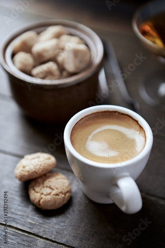 Cup of coffee with amaretti (Italian biscuits) on rustic wooden background. Close up.  © Eugeniusz Dudziński