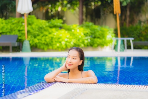 Portrait beautiful young asian woman smile relax leisure around outdoor swimming pool