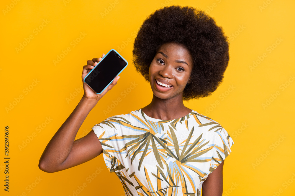 Portrait of nice pretty curly hair lady showing telephone wear print t-shirt isolated over yellow color background Portrait of nice pretty curly hair lady showing telephone wear print t-shirt isolated over yellow color background