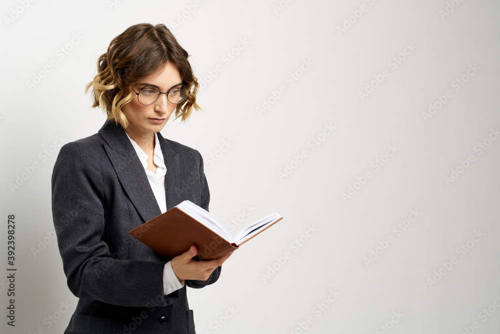 business woman in a suit with documents in hands light background curly hair hairstyle business woman in a suit with documents in hands light background curly hair hairstyle