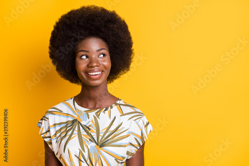Close up portrait of adorable curly hairstyle person look empty space isolated on yellow color background © deagreez