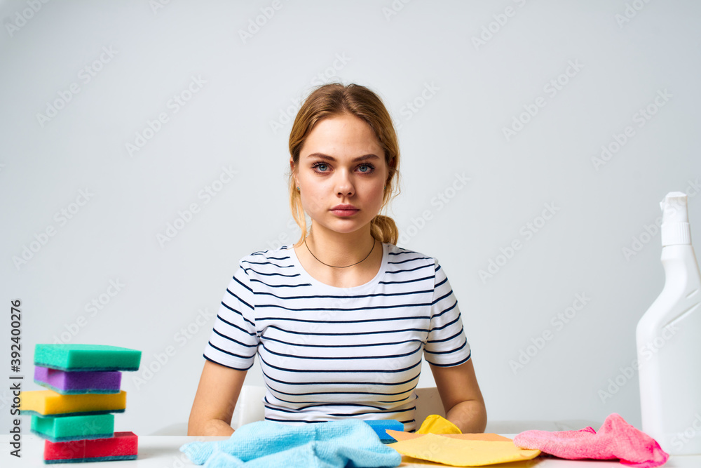 The cleaning lady sits at the table detergent work service The cleaning lady sits at the table detergent work service