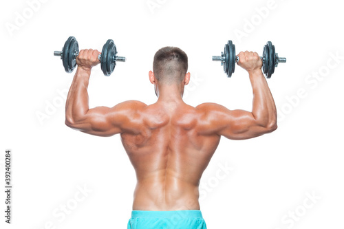 Back view of muscular body and strong hands lifting heavy dumbbells isolated over white background