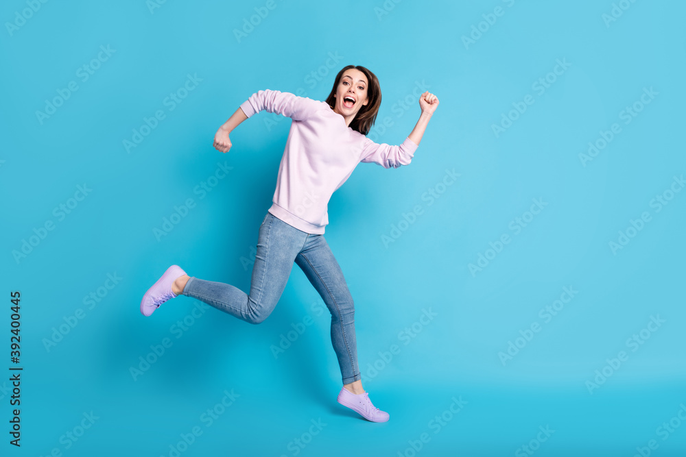 Full body profile side photo of energetic girl run fast after season sales wear violet purple pullover gumshoes isolated over blue color background