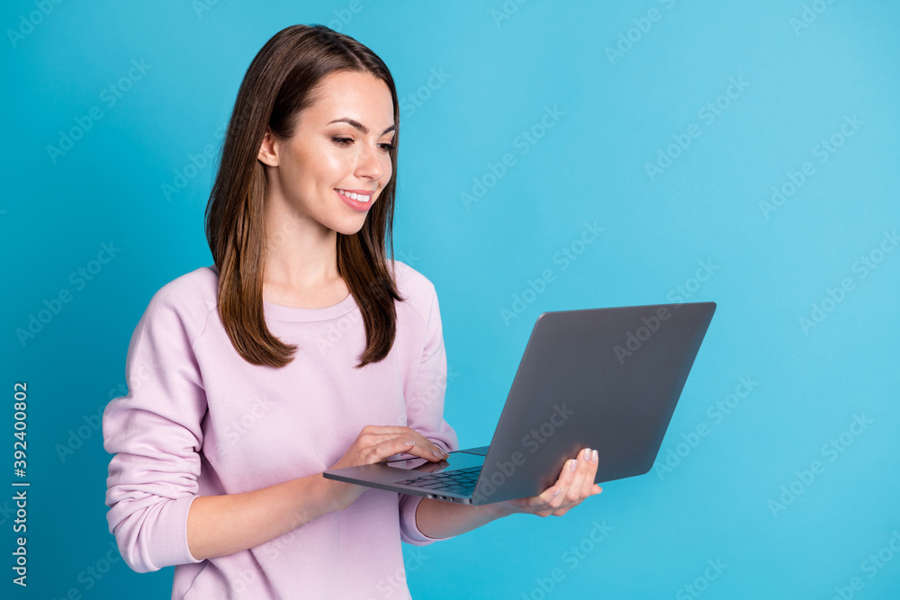 Photo of attractive student lady hold notebook hands modern technology user making homework online chat group mates wear casual purple sweatshirt isolated blue color background Photo of attractive student lady hold notebook hands modern technology user making homework online chat group mates wear casual purple sweatshirt isolated blue color background