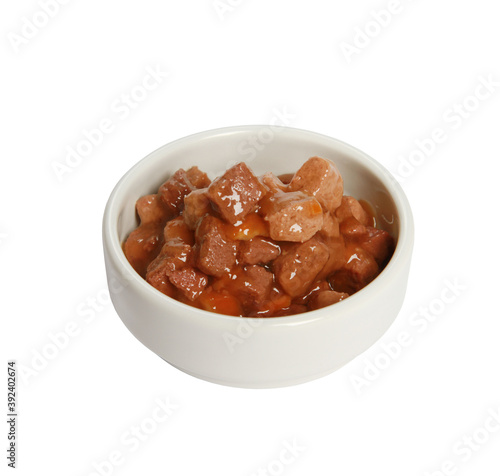 Closeup shot of a white bowl with meat cat food isolated on a white background