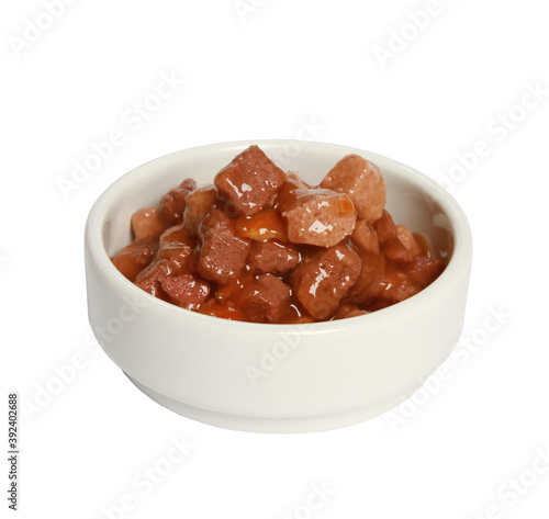 Closeup shot of a white bowl with meat cat food isolated on a white background
