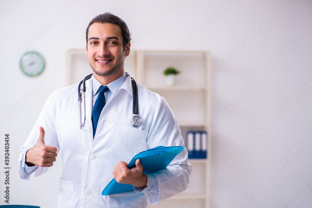 Young male handsome doctor working in the clinic Young male handsome doctor working in the clinic