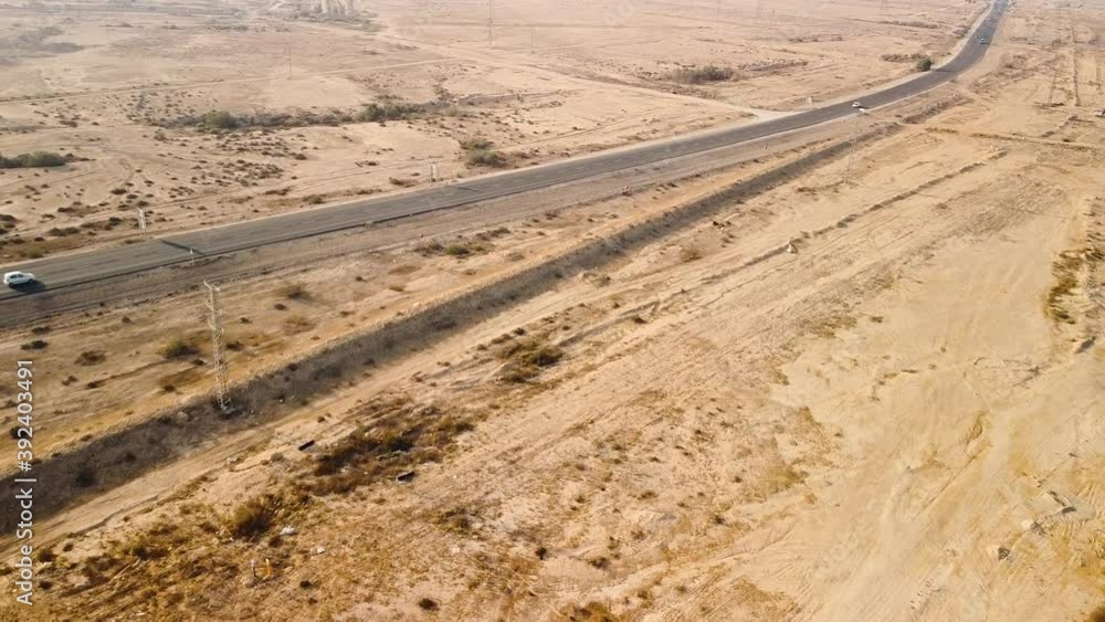 Top view of dangerous overtaking in front of an oncoming vehicle on a highway in the desert Top view of dangerous overtaking in front of an oncoming vehicle on a highway in the desert
