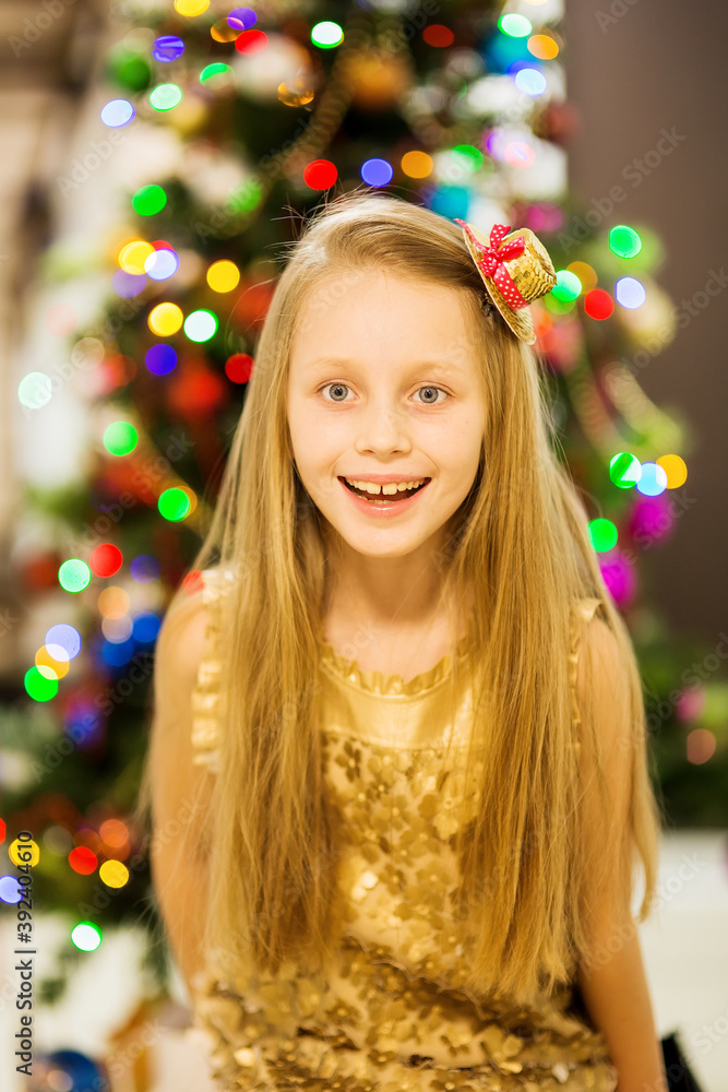 Happy joyful girl on the background of the New Year tree. Merry Christmas Happy joyful girl on the background of the New Year tree. Merry Christmas