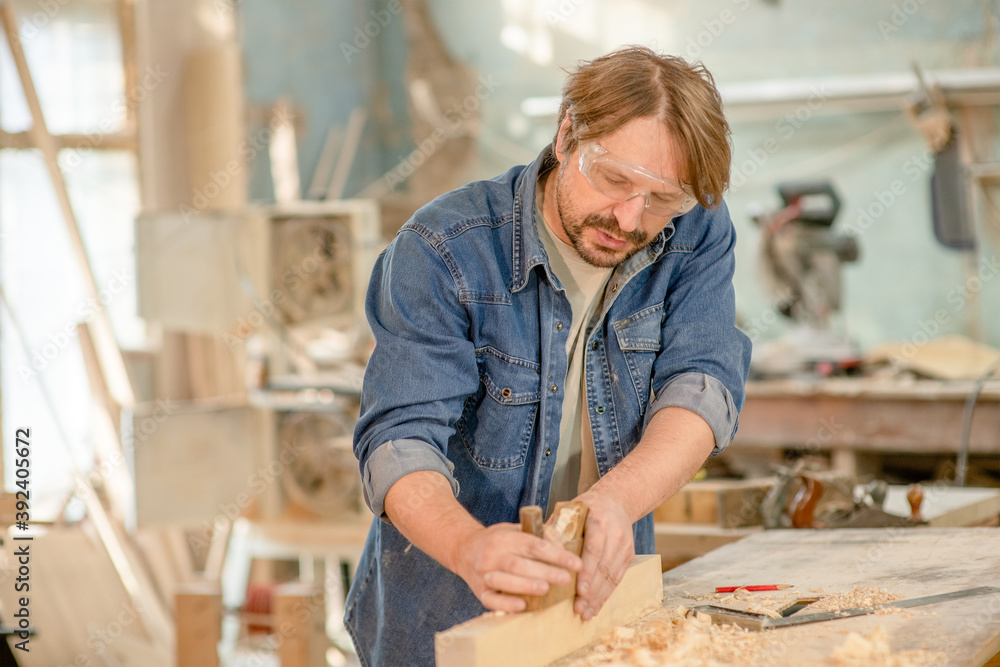 Carpenter planed wood in a workshop Carpenter planed wood in a workshop