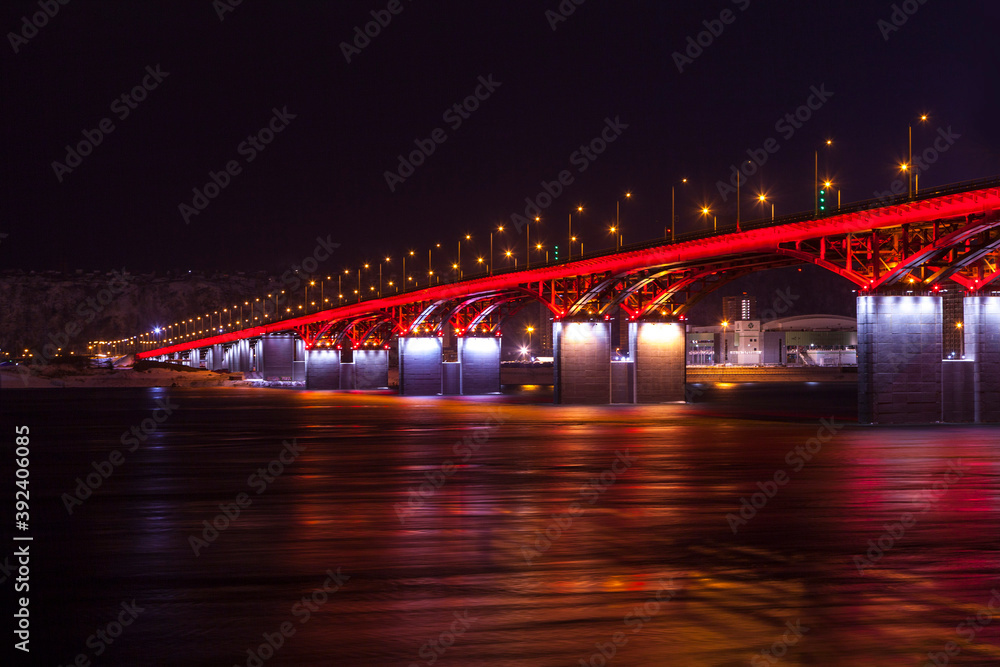 background bridge with illuminated river, at night