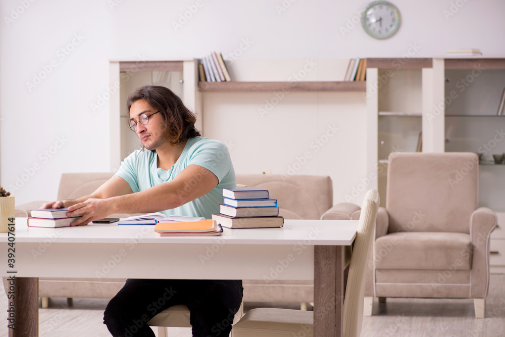 Young male student preparing for exams at home Young male student preparing for exams at home