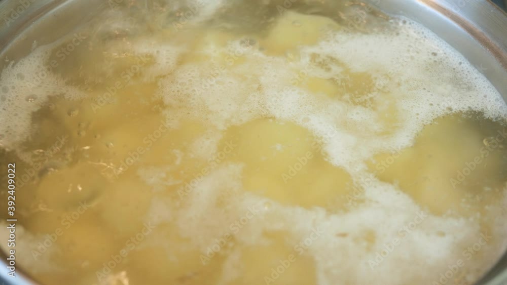 Potatoes Boiled in Hot Water in a Saucepan on the Cooking Stove Potatoes Boiled in Hot Water in a Saucepan on the Cooking Stove