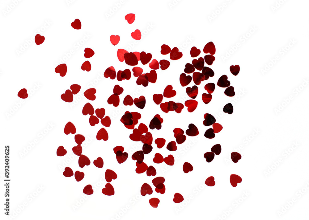 Heart shaped red confetti on white background