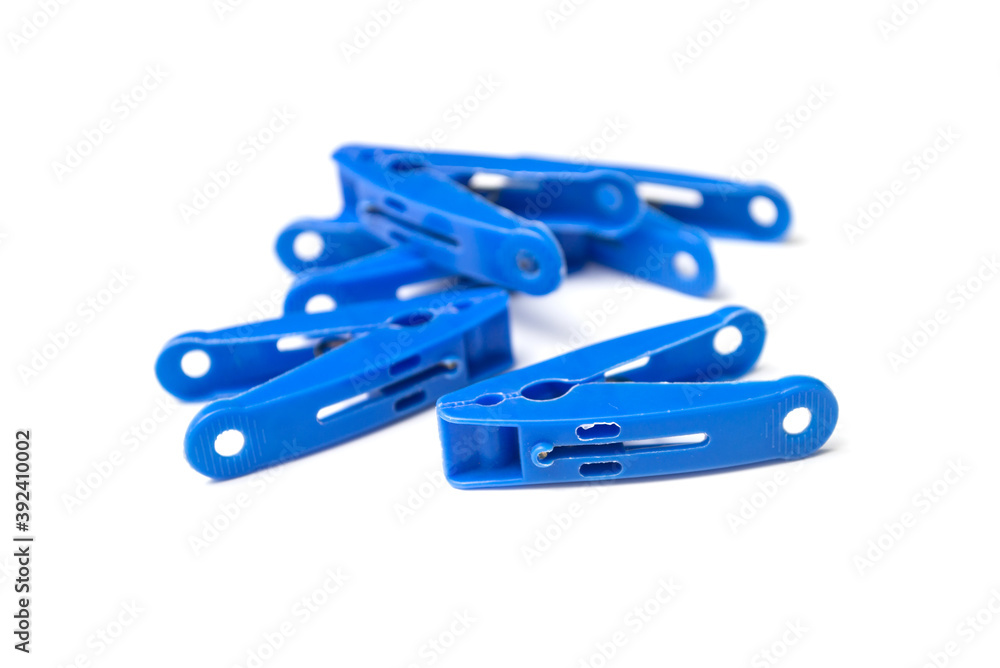 Closeup of blue plastic clothespins on white background Closeup of blue plastic clothespins on white background