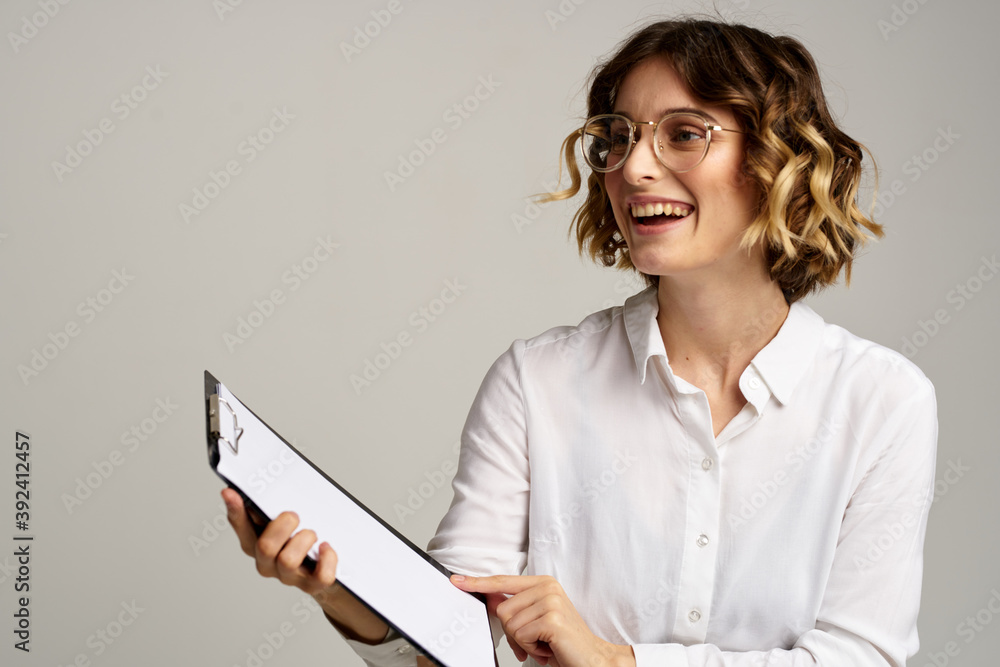 Business woman with folder of documents in hands on gray background cropped view of work Business woman with folder of documents in hands on gray background cropped view of work